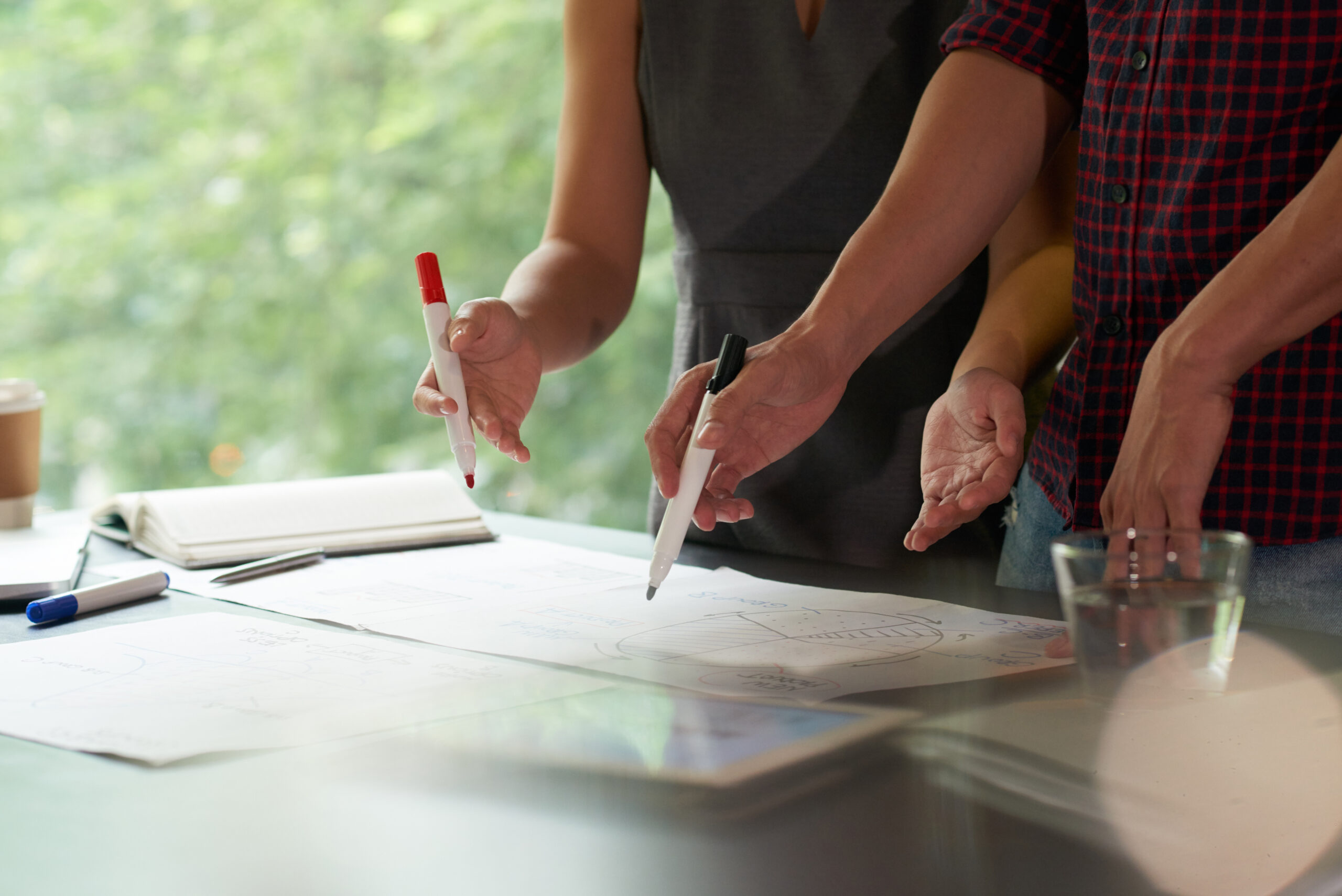 Cropped image of business people discussing information in financial reports